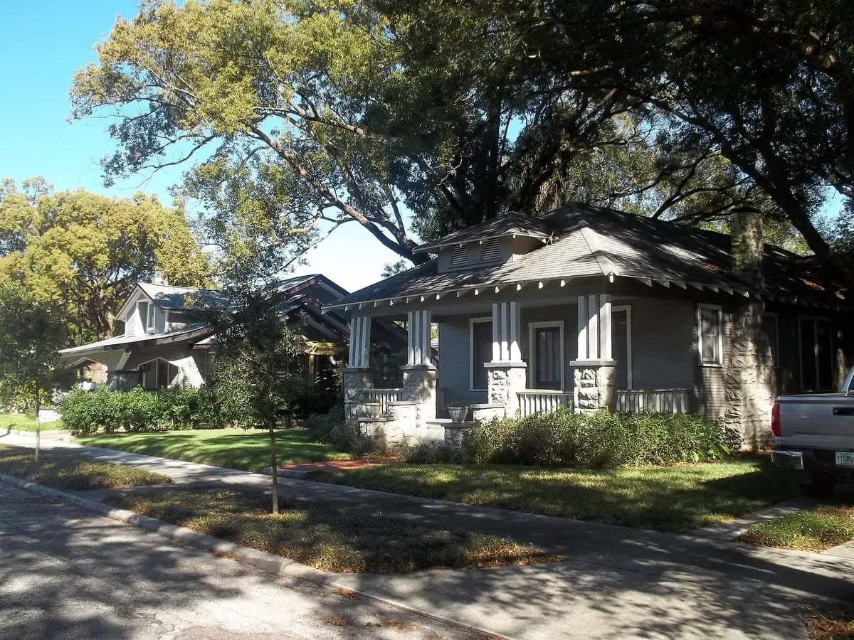Craftsman bungalows with hipped shingle roofs and stone porch piers in Seminole Heights