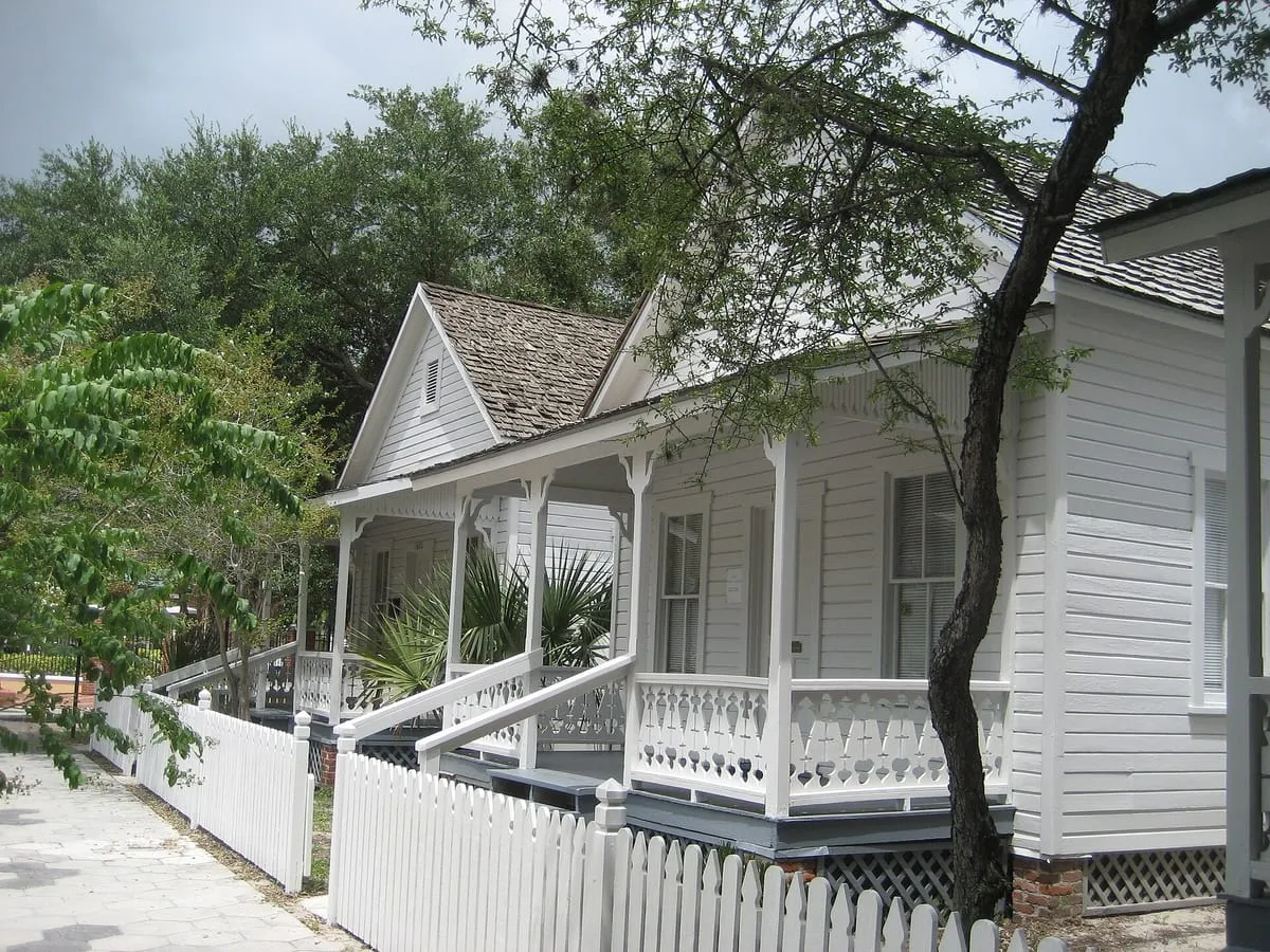 Restored wood-frame cigar workers’ cottages with shake roofs at the Ybor City Museum in Tampa